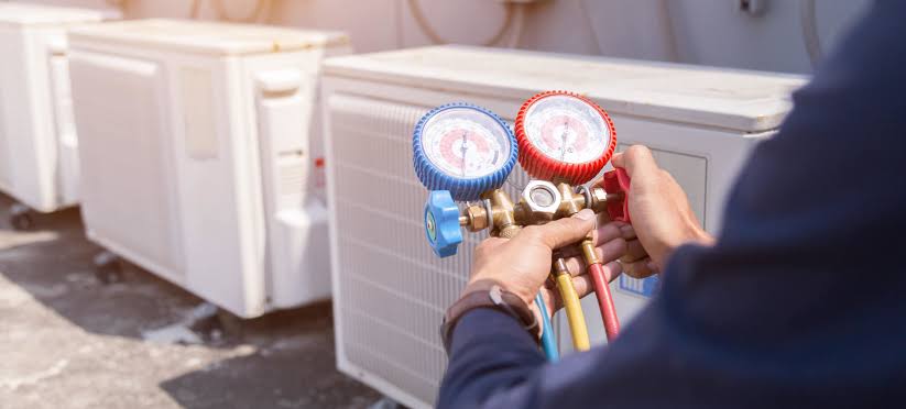 Technician checking an HVAC system with professional pressure gauges