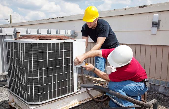 HVAC technicians servicing residential heating and cooling equipment