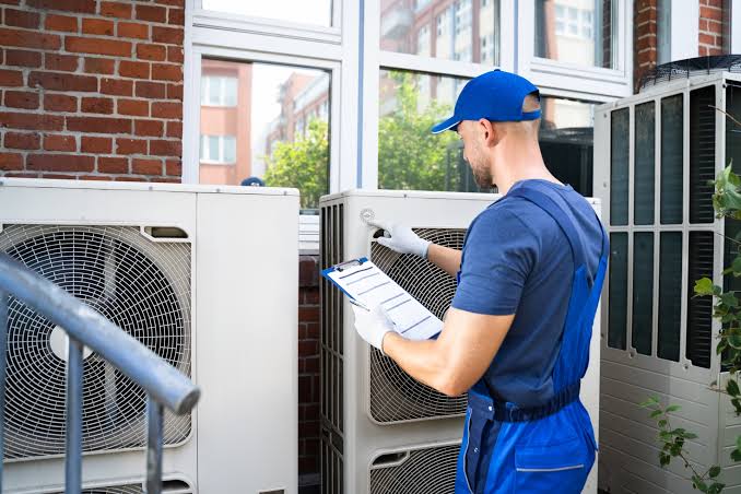 HVAC specialist inspecting residential outdoor systems